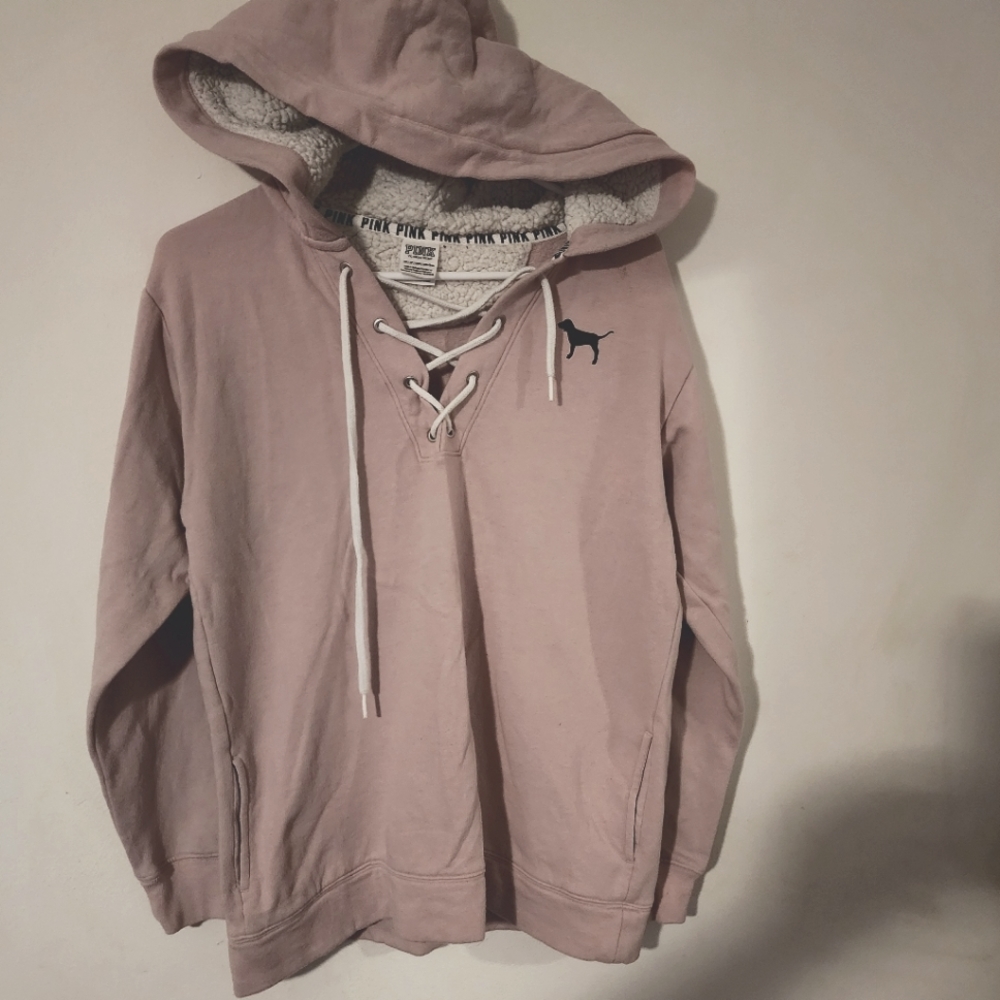 Pink Hoodie with String crossed tie in front.